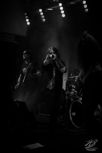 Black Metal band Inverted Saint live with guitar player singer and bass player and drummer